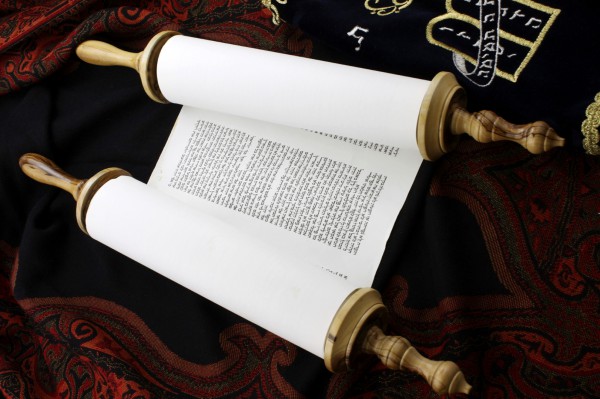 An opened Torah scroll resting on the bimah Torah scroll-bimah