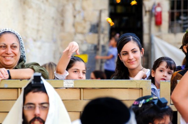 Jewish women throw candy to the men's side of the Western (Wailing) Wall during a Bar Mitzvah Bar Mitzvah-candy-responsibility for their actions