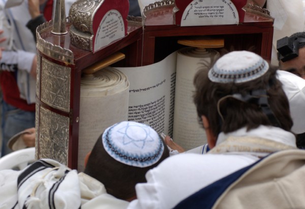 Jewish men pay respect to the open Torah scroll Reading the Torah-tik