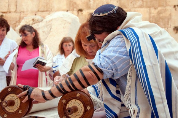 A woman reads from the Torah scroll in Jerusalem near the Western (Wailing) Wall. (Photo by Josh Evnin) A woman reads from the Torah scroll in Jerusalem near the Western (Wailing) Wall. (Photo by Josh Evnin)