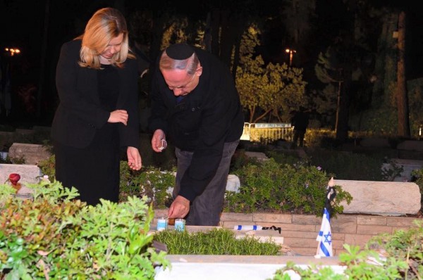 Netanyahu lights a memorial candle for his brother Prime Minister Benjamin Netanyahu and his wife Sara pay tribute to Israel's fallen soldiers at the Mount Herzl cemetery in Jerusalem, lighting a candle for Yonatan Netanyahu.