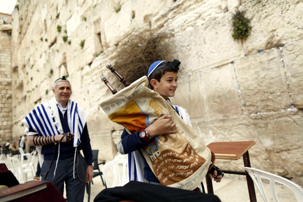 Bar-Mitzvah-at-the-Kotel A 13-year-old Jewish boy carries the Torah scroll at the Western (Wailing) Wall. (Israel Ministry of Tourism photo by Jonathan Sindel)
