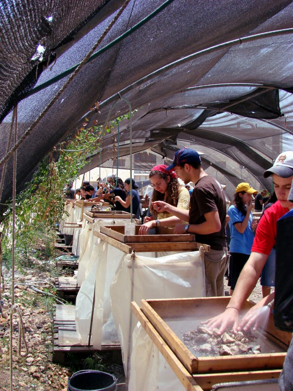 Volunteers for the Temple Mount Sifting project search for coins, pottery, and other finds as they clean debris excavated from the Mount during the building of the El Marwani Mosque in Solomon's Stables. Temple Mount-debris-rubble-archaeology