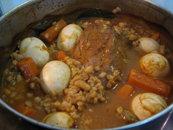 Cholent, a slow-cooked Shabbat stew, can include a variety of ingredients such as this stew with potatoes, meat, barley, and carrots.